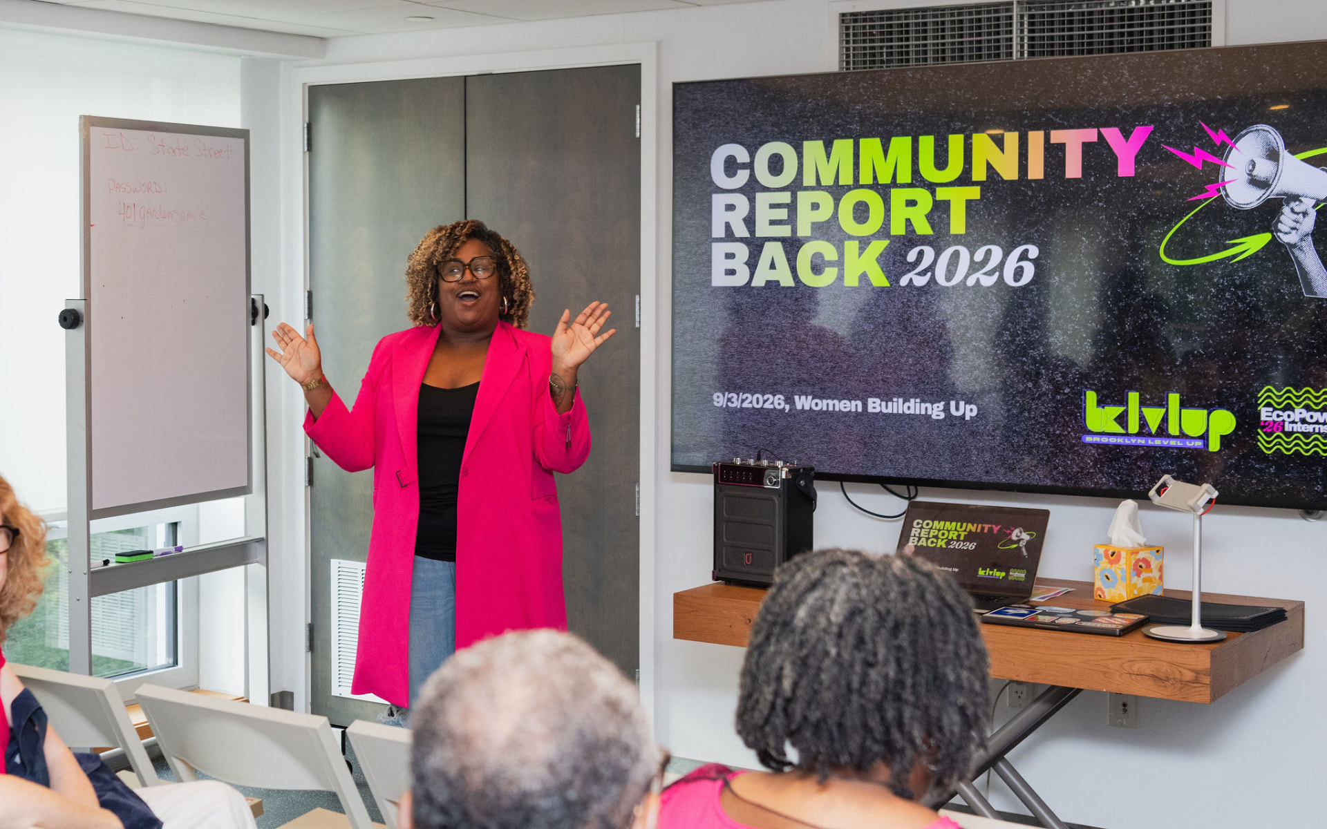 Opening remarks in front of the Community Report Back 2026 screen